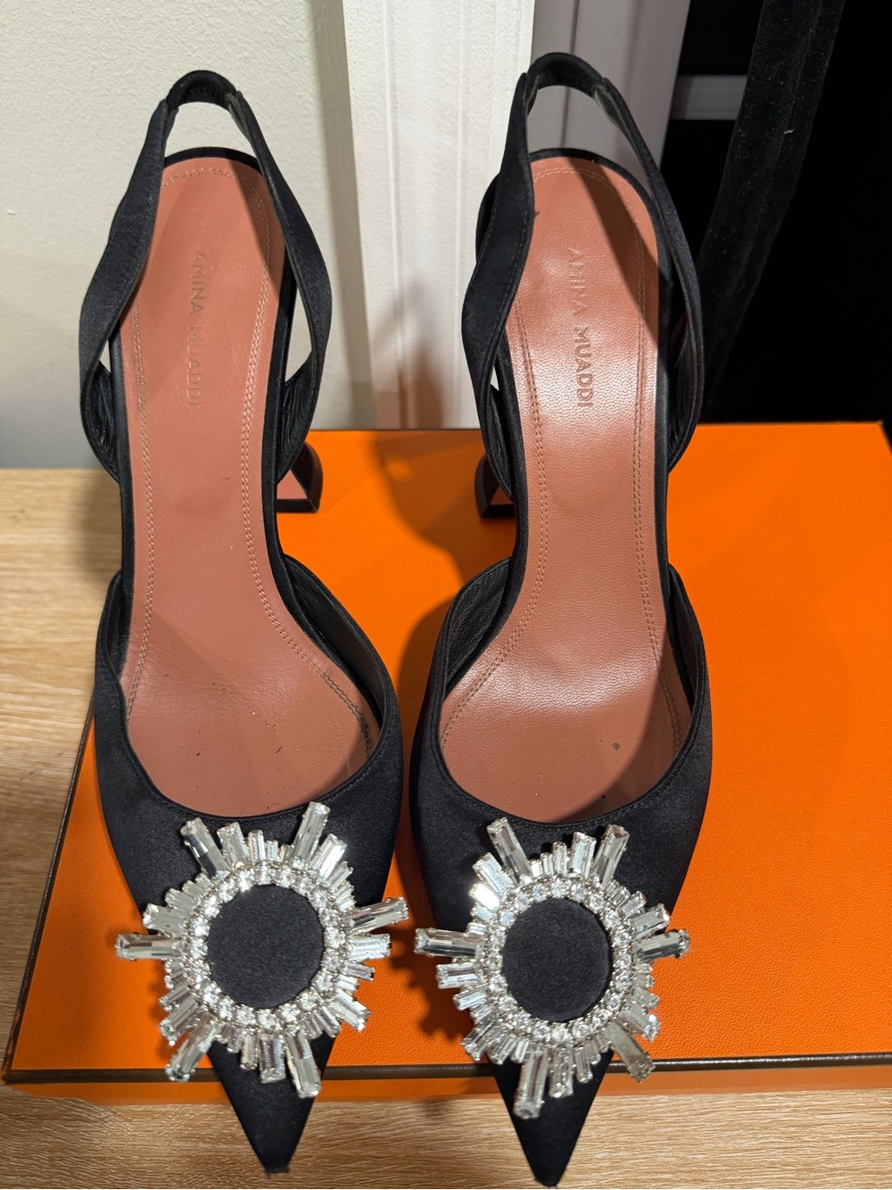 Amina Muaddi Black Pointed Slingback Heels with Crystal Sunburst